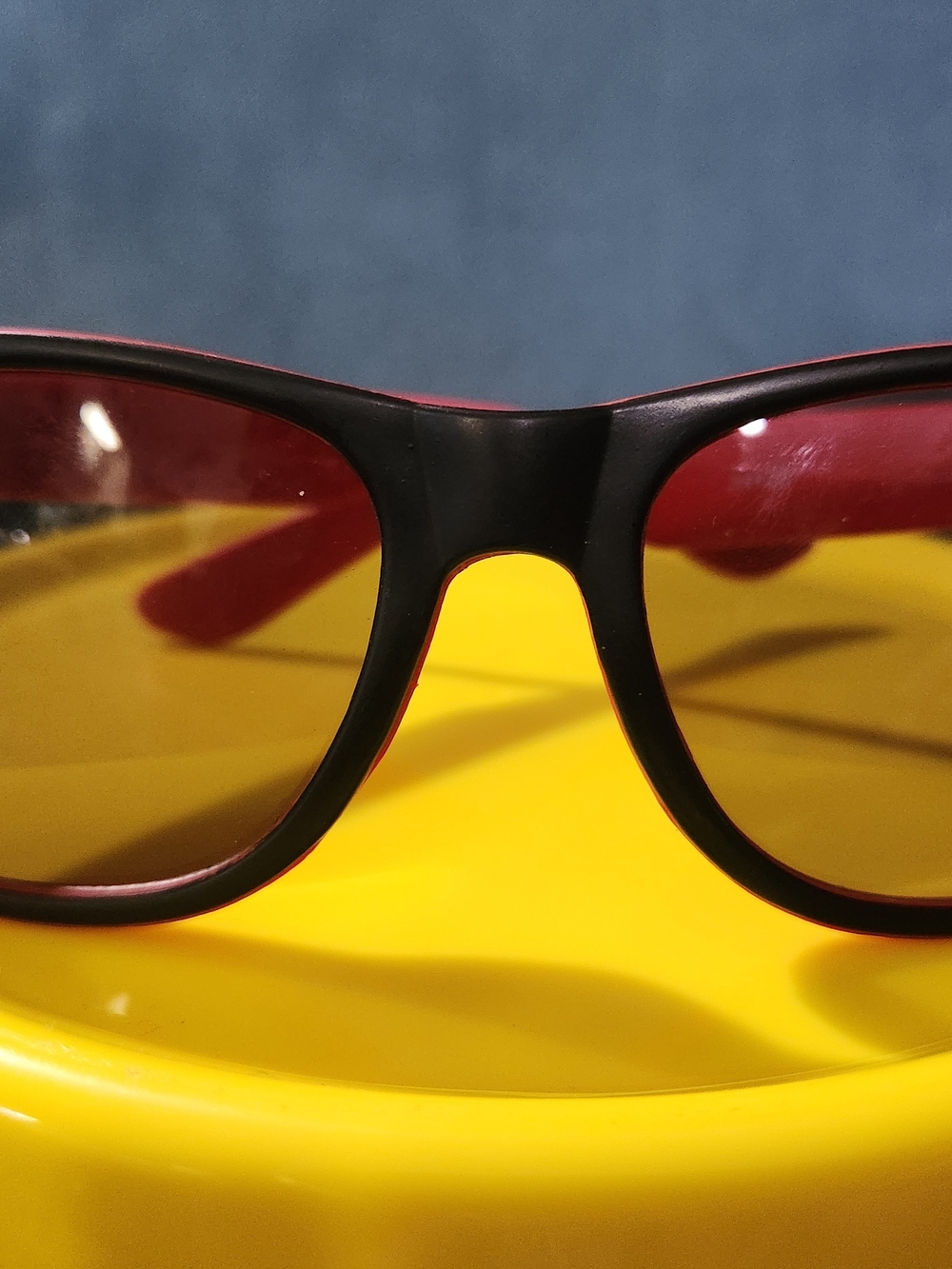 Black Frame Sunglasses with Red Trim and Yellow Lenses